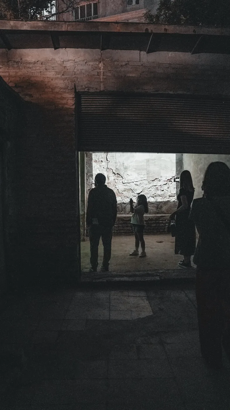 Visitors share a projection in a disused industrial room.