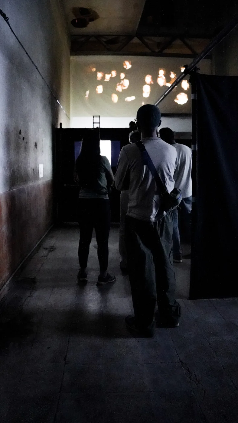 Visitors pass through the exhibition’s industrial interior.